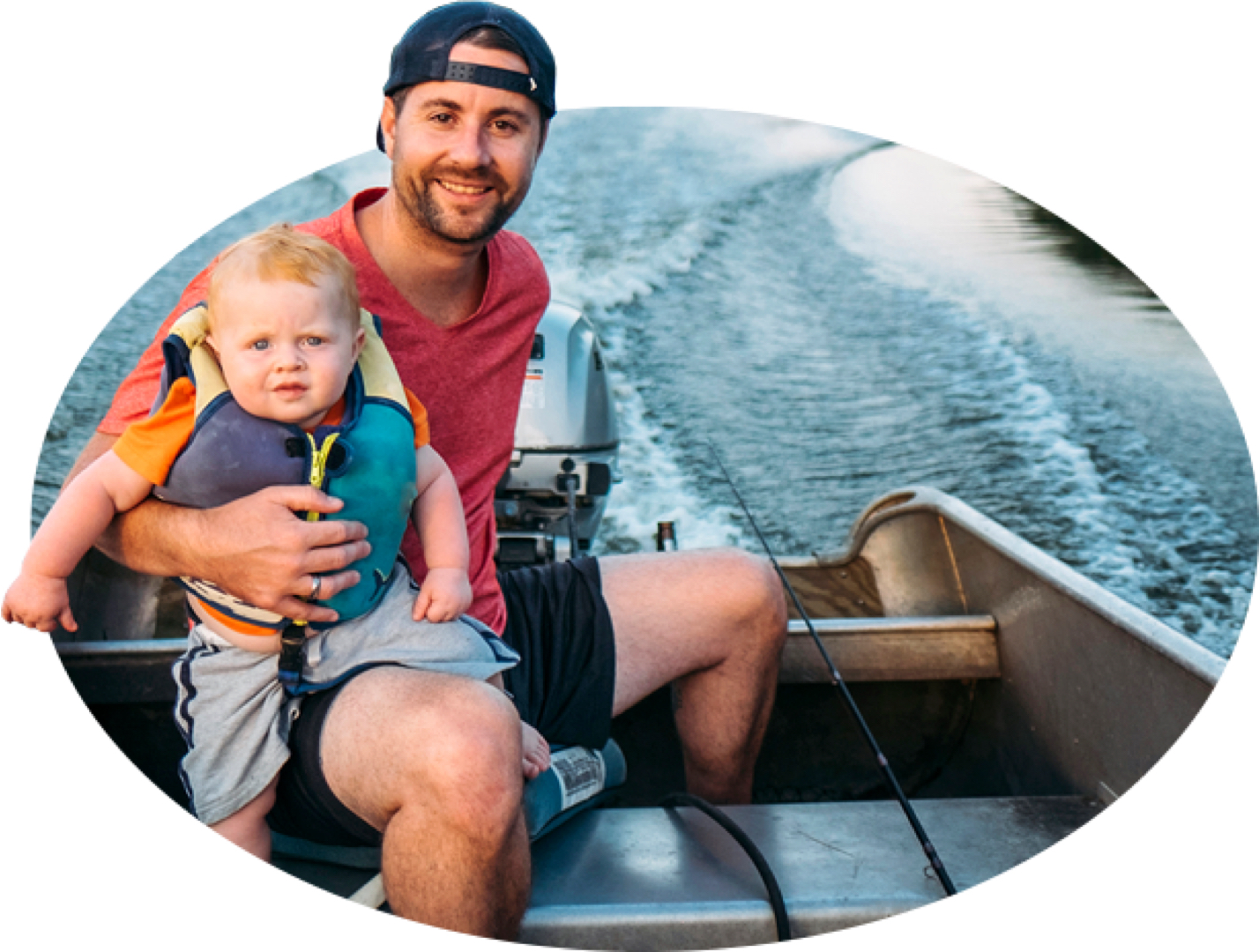 A bearded young father and his life-jacket-wearing toddler motor across the water in a fishing boat, one of the many types covered by State Farm boat insurance.