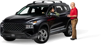 A State Farm agent speaks with a customer in a vehicle.