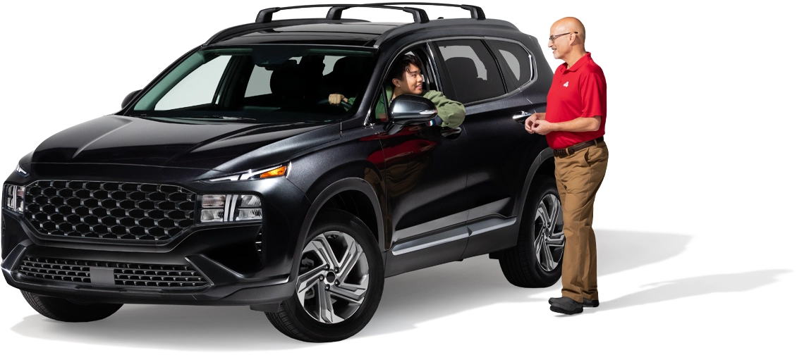 A State Farm agent speaks with a customer in a vehicle.