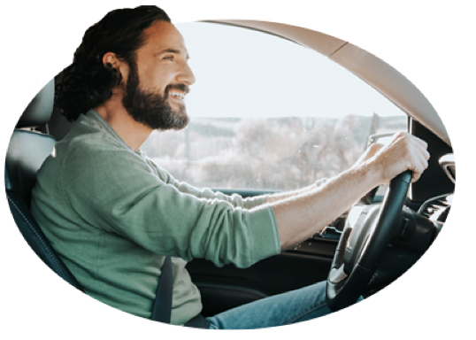 A man shows his good driver skills by checking his rearview mirror.