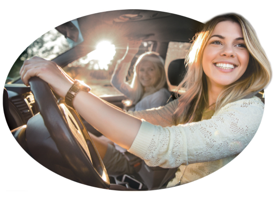 A smiling woman enjoys her safe-driving discount