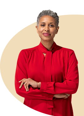 With arms folded, a mature female State Farm agent in a red blouse and scarf smiles.