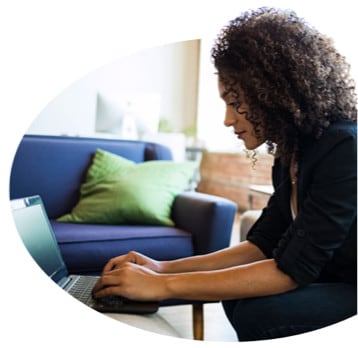 Woman leaning over laptop computer