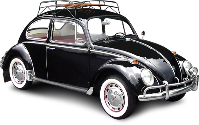 A classic black VW bug with a rack on the roof and whitewalls on the tires.