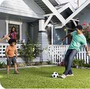 Dad playing soccer with his kid