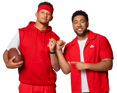 A football player holding a football stands beside a State Farm agent, both wearing red.
