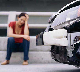 couple looking at car damage