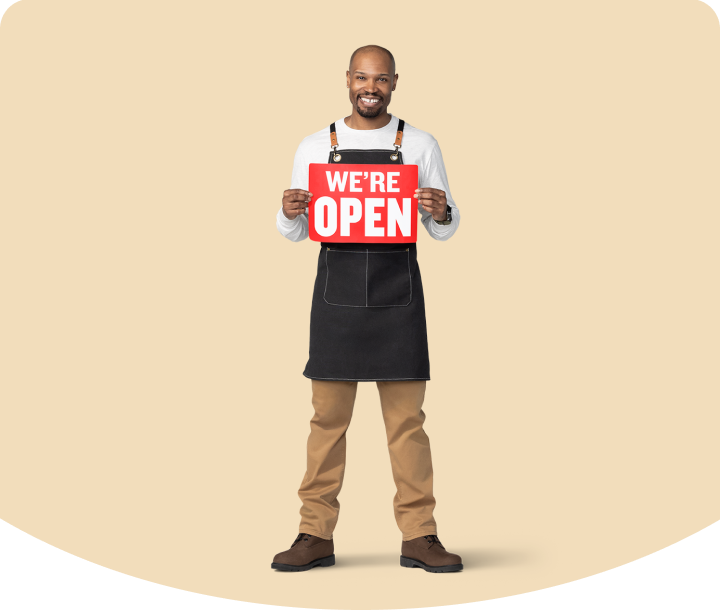 Business owner holding open sign